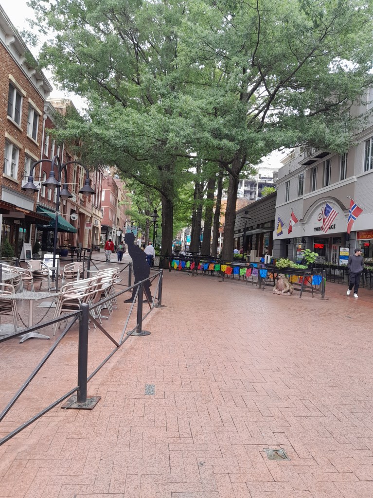 Brick walkway lined with shops.