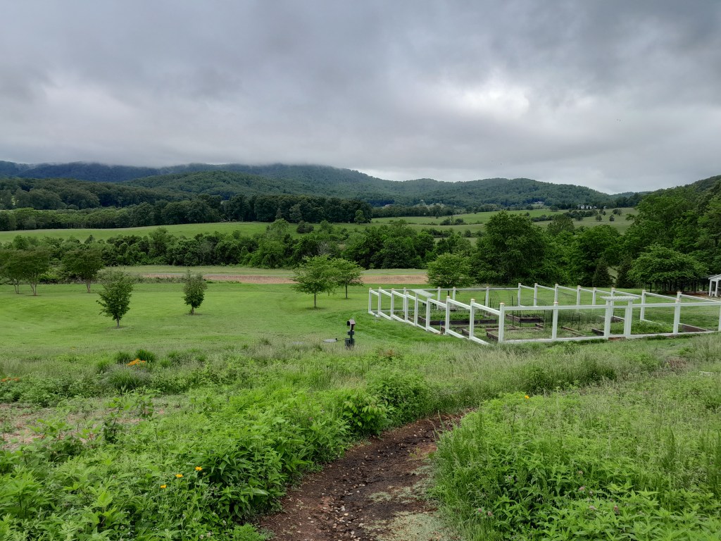 Path down to the garden and mountains in the background