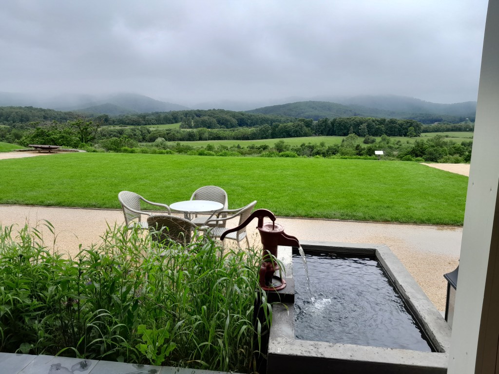 View from the veranda of the winery, old water pump in the foreground and mountains in the distance